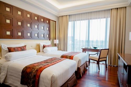 Ένα ή περισσότερα κρεβάτια σε δωμάτιο στο The Sunan Hotel Solo