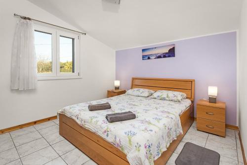 a bedroom with a bed with two towels on it at Regina 1 in Banjole