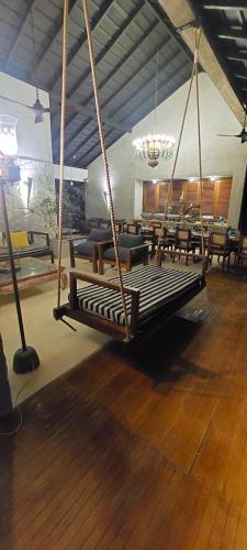 a swing in a room with tables and chairs at Ella Nine Peaks in Ella