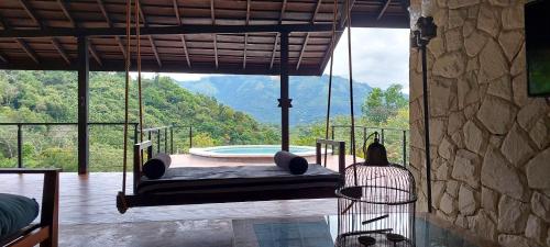 a swing in a room with a view of a mountain at Ella Nine Peaks in Ella