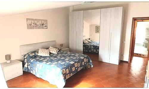 una camera da letto con un letto e uno specchio di Casa vacanze Su Patthiu a Sennori