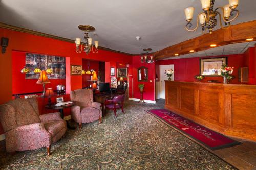 a lobby with red walls and a waiting room at Inn at St John Portland In-Town in Portland