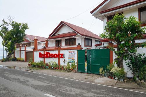 a building with a sign on the side of a street at RedDoorz Plus at Billy's Resort Oslob in Oslob