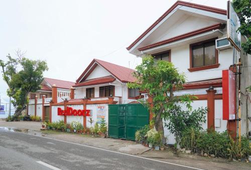 a house on the side of a street at RedDoorz Plus at Billy's Resort Oslob in Oslob