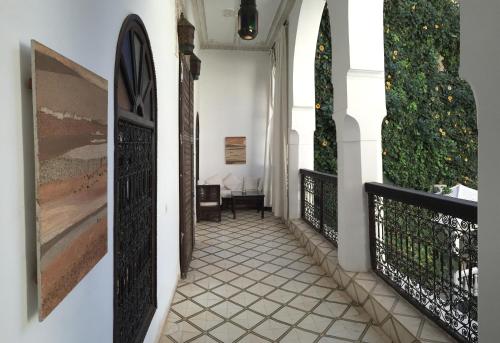 a hallway of a house with paintings on the walls at Riad Dar El Assafir in Marrakech