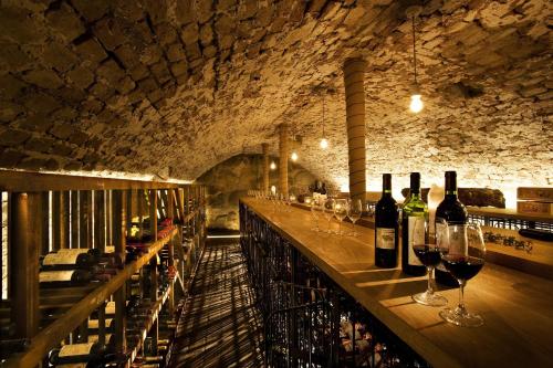 a bar with wine bottles and glasses on it at Ulfsunda Slott in Stockholm