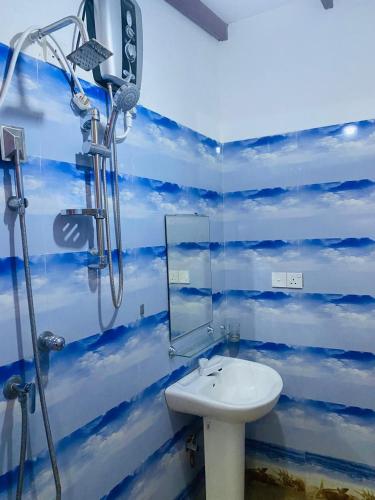 a bathroom with a shower and a sink at Aromin Ayurvedic Palace in Weligama