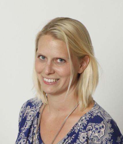 a woman with blonde hair smiles at the camera at Landhaus Lisa in Schladming