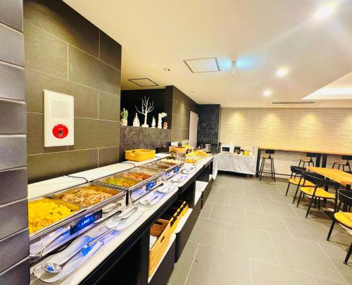 a buffet line with many different types of food at Hotel Arashi Nambaminami No003 in Osaka