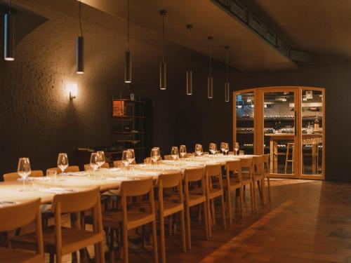 a room with a long table with chairs and wine glasses at Landgasthof Riehen Hotel and Restaurant, Basel in Basel