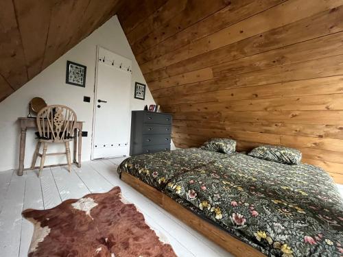 a bedroom with a bed and a wooden wall at Cabin Apartman, Kopaonik in Kopaonik