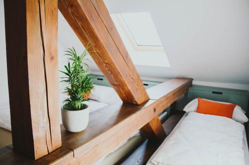 a room with a bed and two potted plants at Apartmán Kukučínova in Banská Bystrica