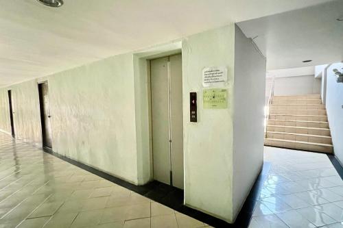 a hallway of a building with stairs and a elevator at Udoncabana in Udon Thani
