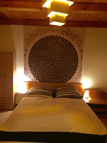 a bedroom with a bed with a large headboard at Willa Brzozówka in Milówka