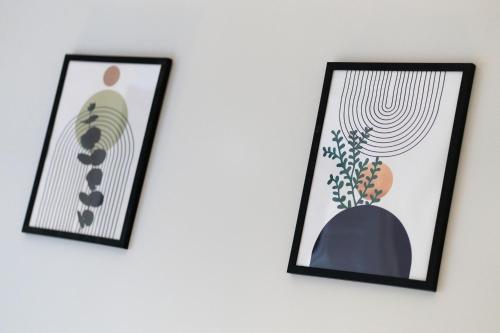 two framed pictures on a white wall at Lochside Apartments, Apt C in Montrose
