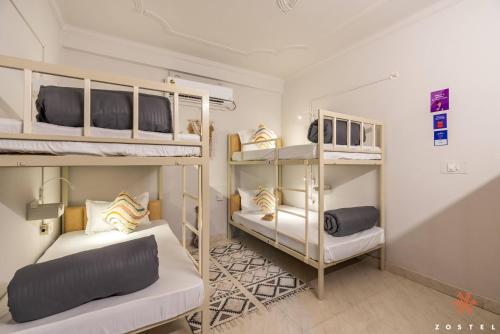 a room with two bunk beds and a couch at Zostel Rishikesh, Tapovan in Rishīkesh