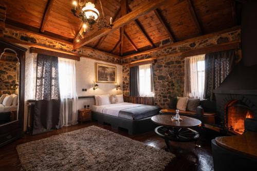 a bedroom with a bed and a fireplace at 4 Seasons Premium Chalet & Massage Treatments in Palaios Agios Athanasios