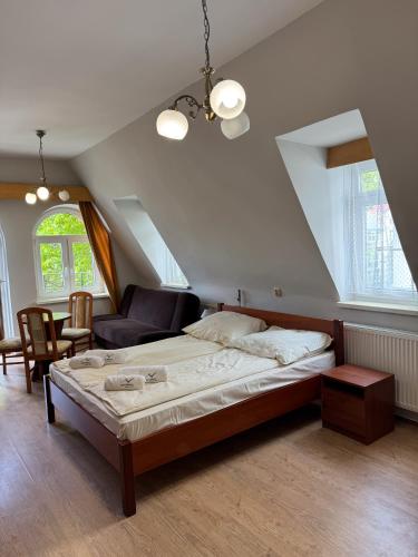 a bedroom with a large bed and a living room at Meduza Natura Tour in Świnoujście