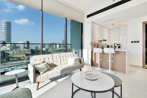 a living room with a couch and a table at Savis Home - Enjoy the City Skyline View 1BR in Binghatti Venus JVC in Dubai