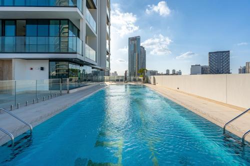 a swimming pool on the side of a building at Savis Home - Enjoy the City Skyline View 1BR in Binghatti Venus JVC in Dubai