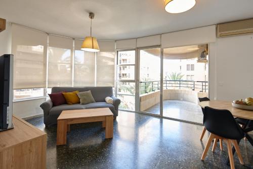 a living room with a couch and a table at Eco-Manolita Ripoll in Elche
