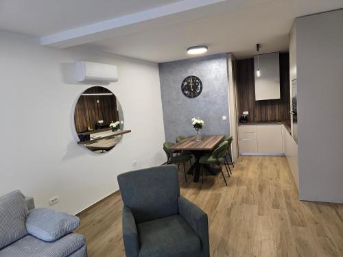 a living room and dining room with a table and chairs at Apartman FIŠBAH II 1 self CHECK-IN, FREE PRIVATE PARKING in Osijek