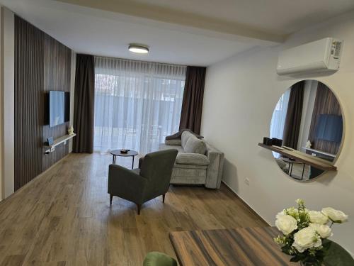 a living room with a couch and a chair at Apartman FIŠBAH II 1 self CHECK-IN, FREE PRIVATE PARKING in Osijek