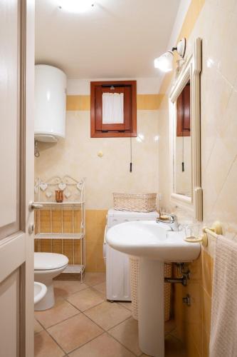 a bathroom with a sink and a toilet at Maestrale Aris - Klodge in Olbia
