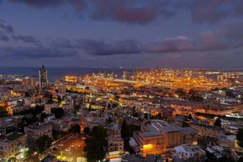 a view of a city at night with lights at Haifa Tower Hotel - מלון מגדל חיפה in Haifa