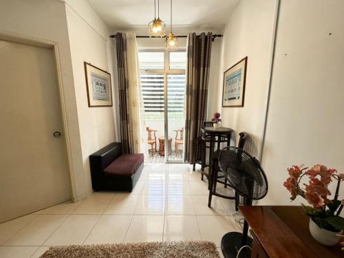 a living room with a couch and a table at Residence Homestay Wakaf Che Yeh in Kota Bharu