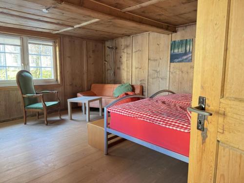 a bedroom with a bed and a couch and a table at Revier musisch und historisch in Diesbach