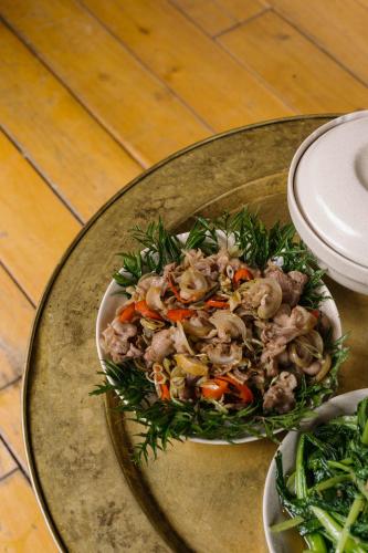 a bowl of food on a glass plate on a table at TOKI Cottage Đam Khê in Vũ Lâm