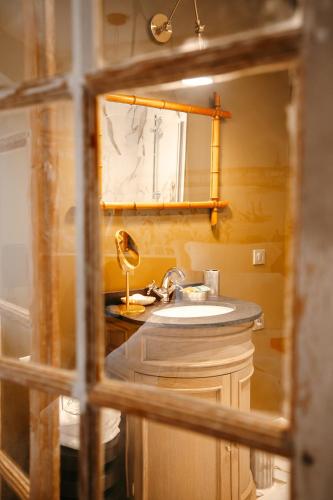 une salle de bain avec un lavabo et un miroir dans l'établissement Magnifique Studio, Bord de mer, Sur la plage, à Pleudihen-sur-Rance