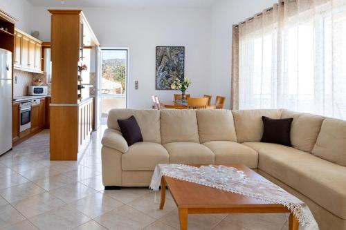 a living room with a couch and a table at Iconic Villa with private pool and sea view in Próvarma