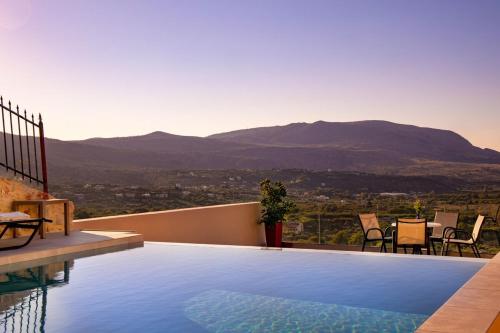 a swimming pool with a view of a mountain at Iconic Villa with private pool and sea view in Próvarma