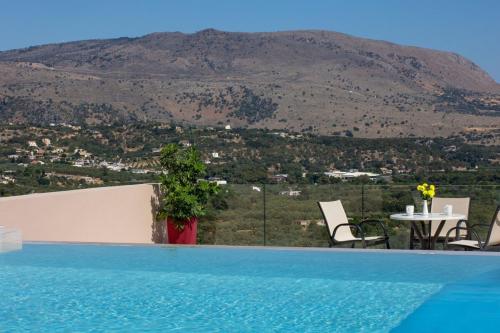 a swimming pool with a view of a mountain at Iconic Villa with private pool and sea view in Próvarma