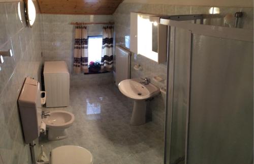 a bathroom with a toilet and a sink and a shower at Altipiani Trentini in Lavarone