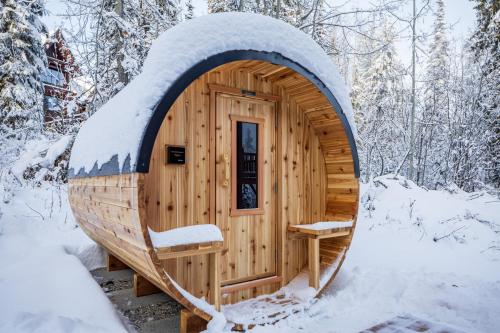 a wooden hobbit house in the snow at Copper Horse Lodge in Golden