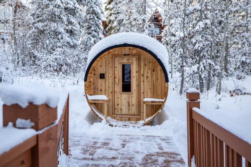 a wooden hobbit house in the snow at Copper Horse Lodge in Golden