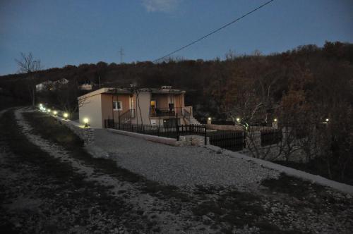 a house with lights on the side of a road at Kuća za odmor Bela Goranci in Mostar