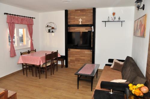 a living room with a couch and a table at Kuća za odmor Bela Goranci in Mostar