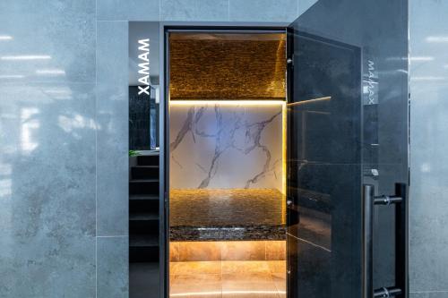 a bathroom with a glass door with a reflection in it at Continental SPA Resort in Bukovel