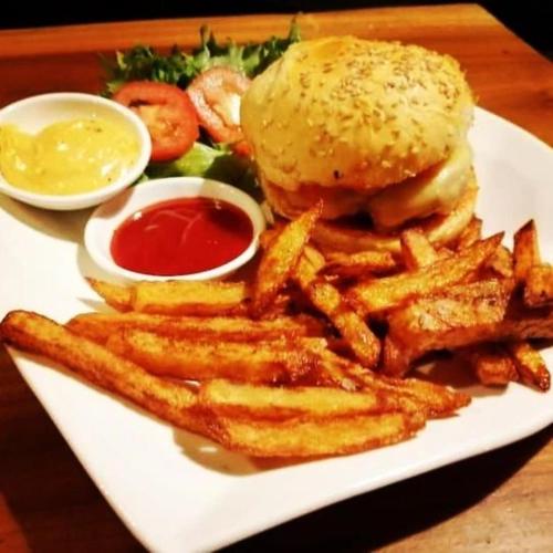 a plate of food with a hamburger and french fries at FANDEE ISLAND Treehouses & Ziplines - Tad Lo, Bolaven Loop Pakse in Ban Kiangtat