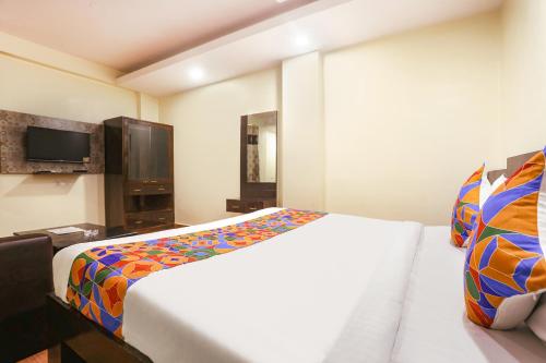 Кровать или кровати в номере FabExpress Rajdeep Palace