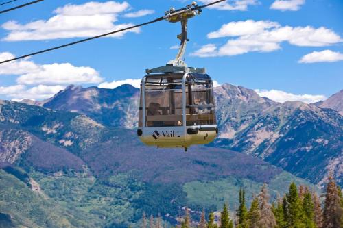 a cable car flying over a mountain valley at Lift House Lodge, Downtown Vail Lionshead Village Studio Condo in Vail