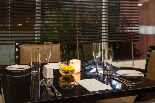 a dining table with wine glasses on top of it at NH Coatzacoalcos in Coatzacoalcos