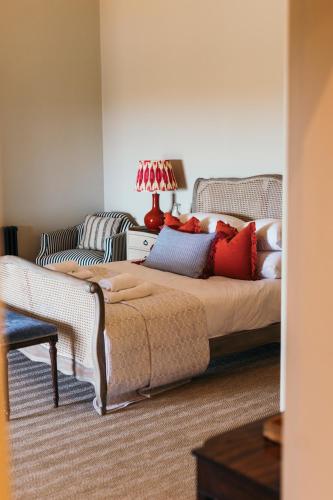 a bedroom with a bed and a couch at Nest Farmhouse in Docking