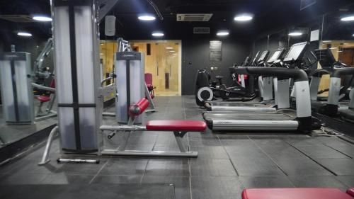 a gym with rows of treadmills and machines at Bristol Hotel Salalah in Salalah