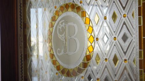 a clock on a wall with a number on it at Bristol Hotel Salalah in Salalah
