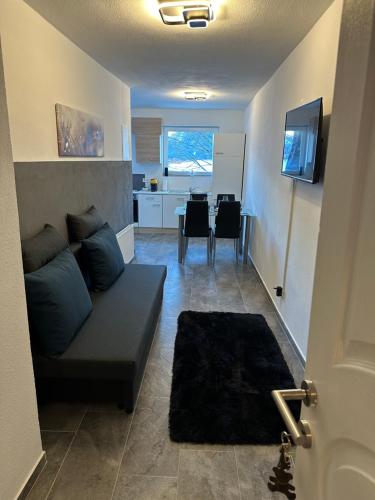 a living room with a couch and a dining room at Apartment Oberleins I in Arzl im Pitztal